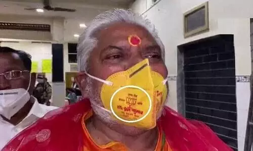 Bihar Minister Prem Kumar in trouble for wearing lotus mask