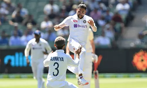 Mohammed Siraj celebrates his maiden test wicket with rahane
