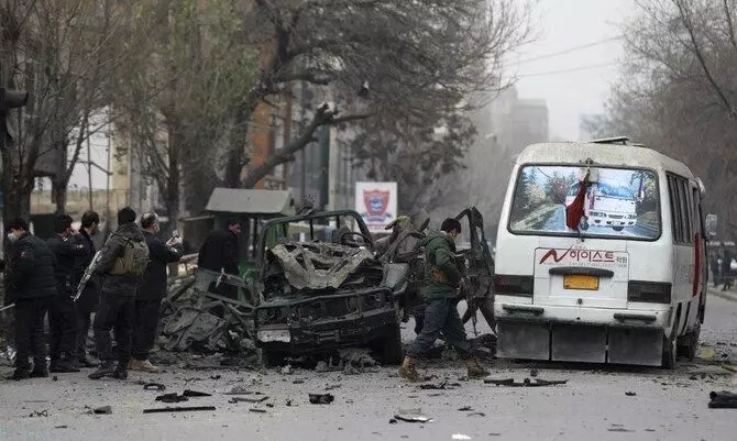 Afghan security personnel inspect the site of a bomb attack in Kabul