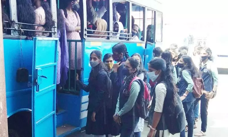 students waiting to get in to bus