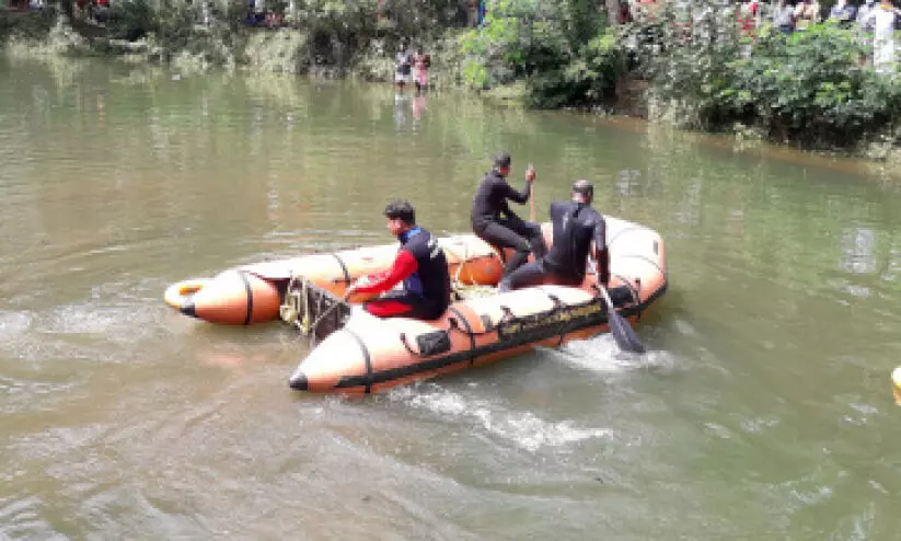 scuba team searching in pond