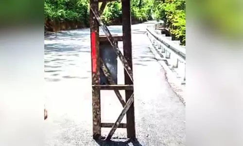 electric post in the middle of road