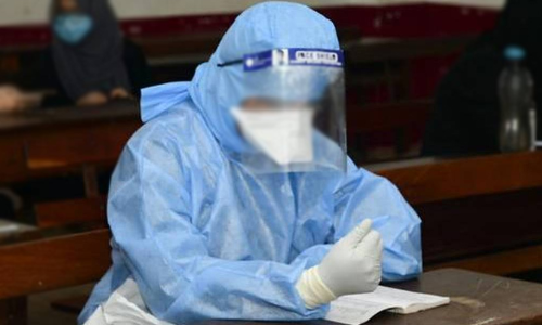 exam writing in PPE Kit