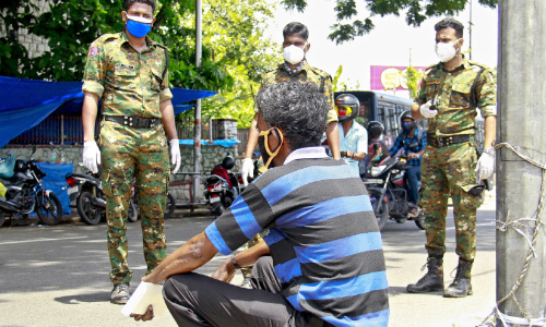 covid patient sitting in road side