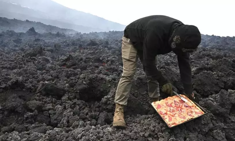 Man cooks pizza on active Pacaya volcano