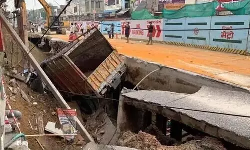 Truck Falls Into Caved Road