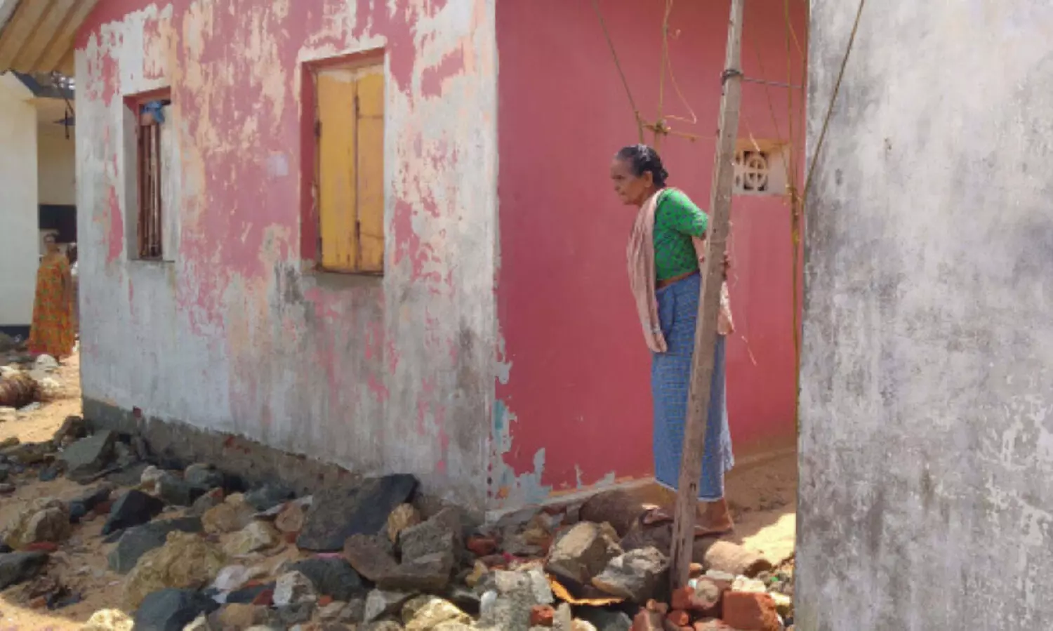 house wife looking to sea with fear