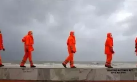 Members of NDRF patrol along a shore ahead of Cyclone Yaas