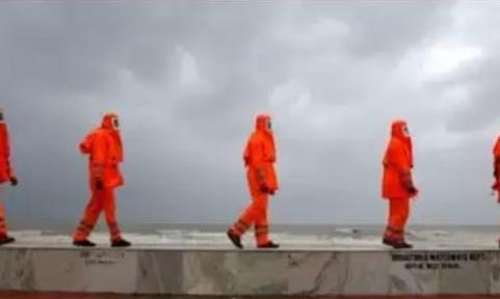 Members of NDRF patrol along a shore ahead of Cyclone Yaas
