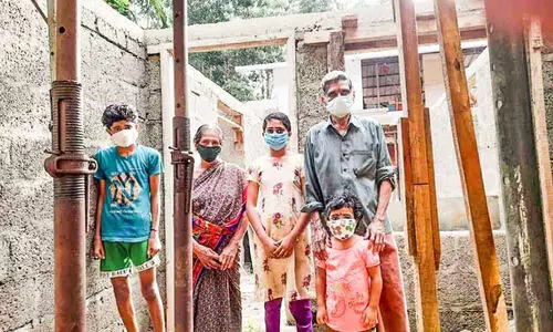 gopi and family infront of constructing home