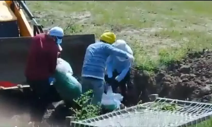 three men using JCB to bury covid 19 fathers body in UP surfaces viral video