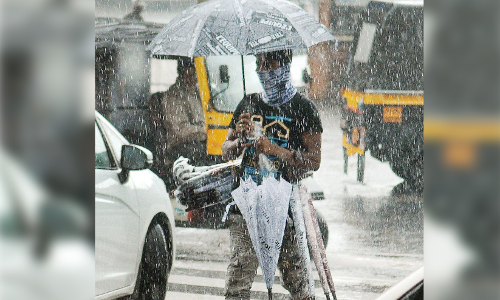 Umbrella seller in heavy rain