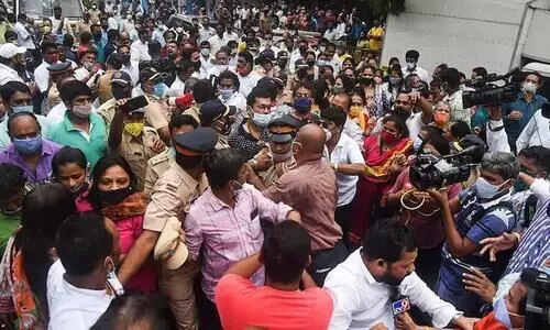 Police personnel attempt to break up the clash between Shiv Sena and BJP workers in Mumbai