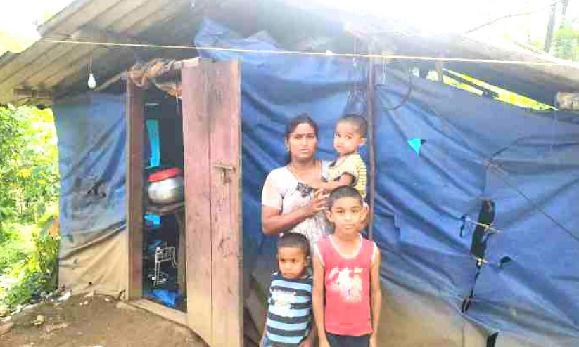 family infront of a poor home family infront of a poor home