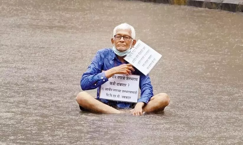 Elderly man sits for 4 hours on flooded road in protest