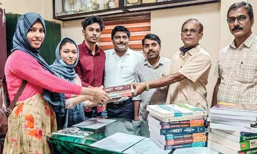 Students donate book to the school