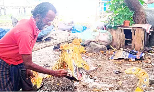 Nasser paints colors on wood