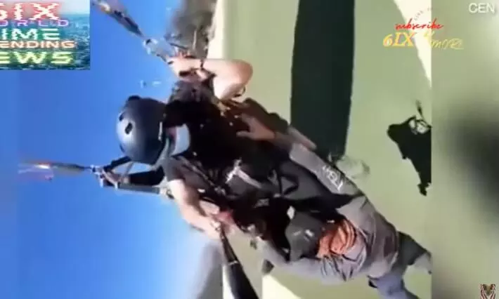 Shocking! Man is left dangling by his hands from paraglider - Watch Viral Video