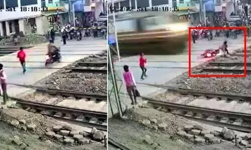 Narrow escape for a man-in-hurry as Rajdhani Express train crushes his bike