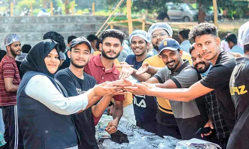 Students serving biryani to help with classmate