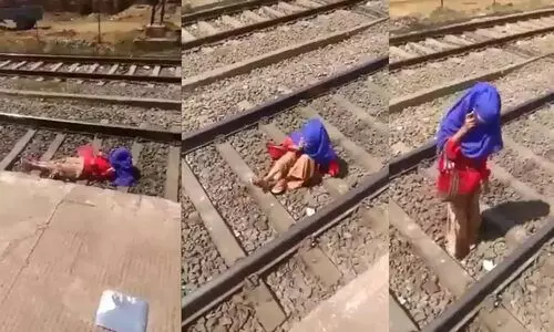 video of woman gossiping over phone while lying on railway track