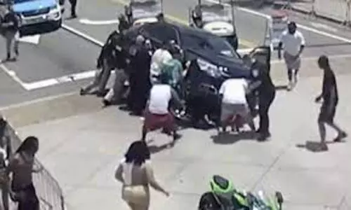Onlookers and police band together to save motorcyclist trapped