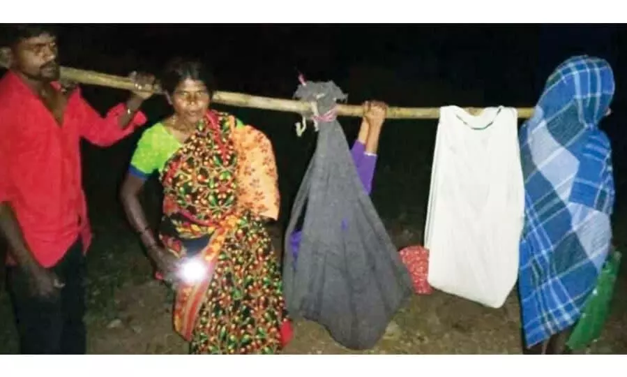 Villagers carry pregnant woman