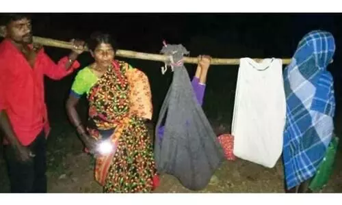 Villagers carry pregnant woman