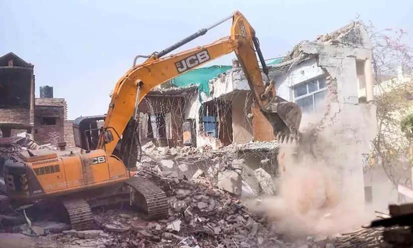 Bulldozer being used to demolish the illegally constructed residence Bulldozer being used to demolish the illegally constructed residence