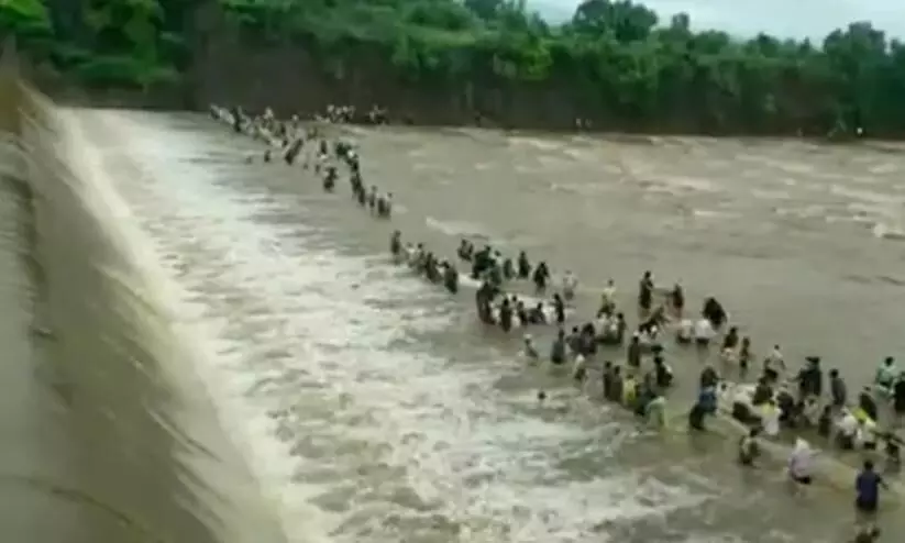 People Fish Dangerously Close To Water Released From Maharashtra Dam People Fish Dangerously Close To Water Released From Maharashtra Dam