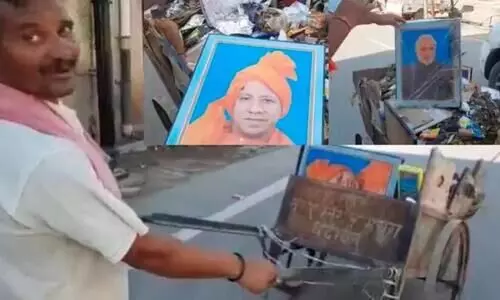 portraits of  Narendra Modi and Yogi Adityanath were found garbage cart