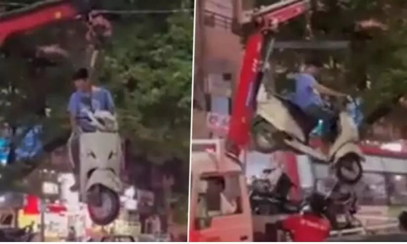 Nagpur traffic police lift scooter from no parking zone with its owner atop, see viral video