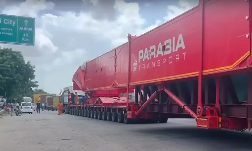 trailer is pulled by multiple trucks, has 256 wheels, and runs 1 km in 4 litres of fuel