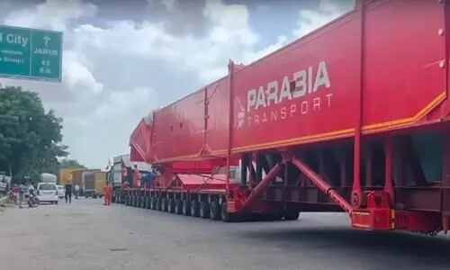 trailer is pulled by multiple trucks, has 256 wheels, and runs 1 km in 4 litres of fuel