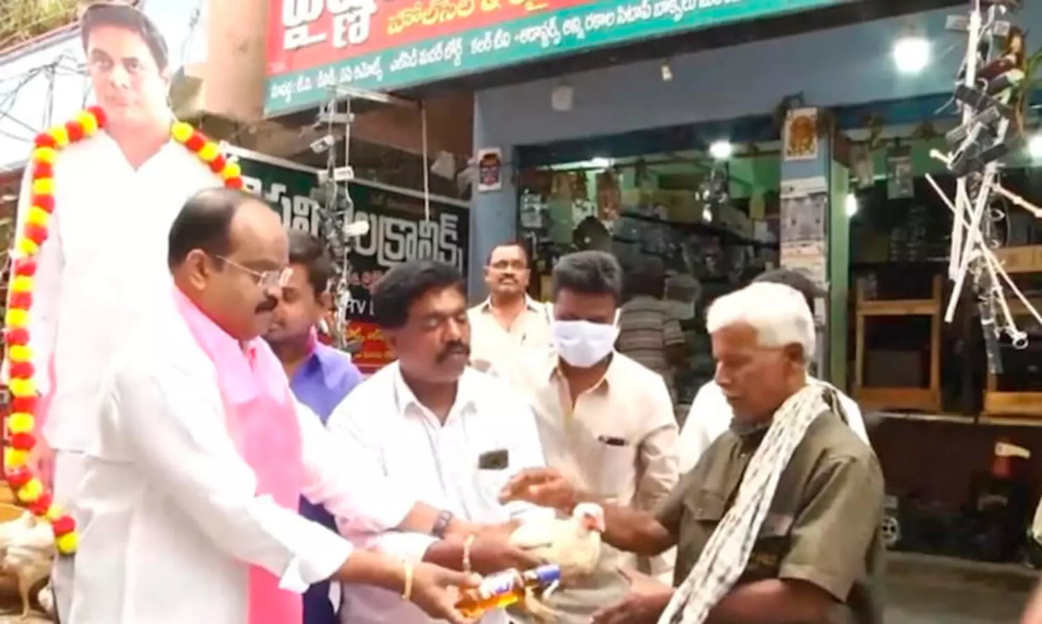 TRS leader distributes liquor, live chicken