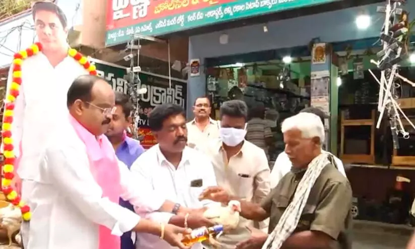 TRS leader distributes liquor, live chicken
