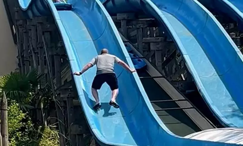 UK father rescues daughter stuck on water slide; video surfaces