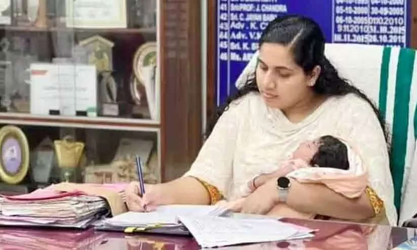 Mayor Arya Rajendran in office with baby