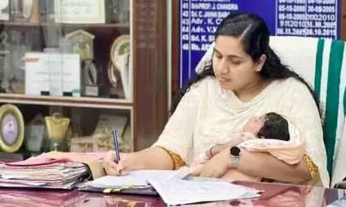 Mayor Arya Rajendran in office with baby