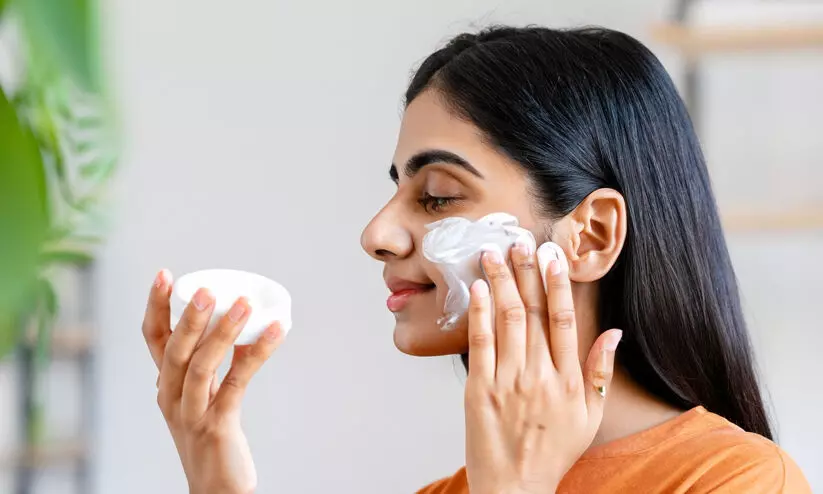 a girl using face cream