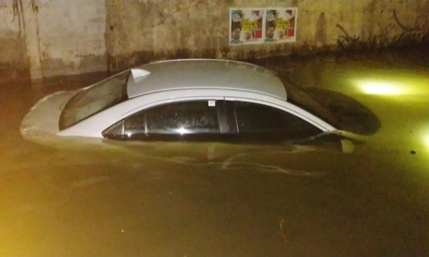 The car sank in the watershed on the railway under bridge