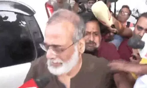 Delhi Police Special Cell officials leave NewsClick office with Founder and Editor-in-Chief of NewsClick Prabir Purkayastha