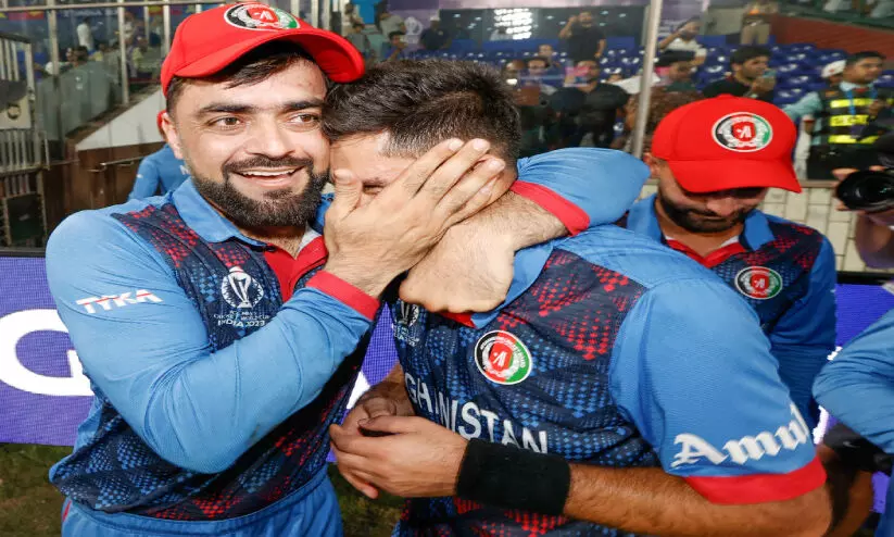 Rashid Khan and Mujibur Rahman celebrate victory