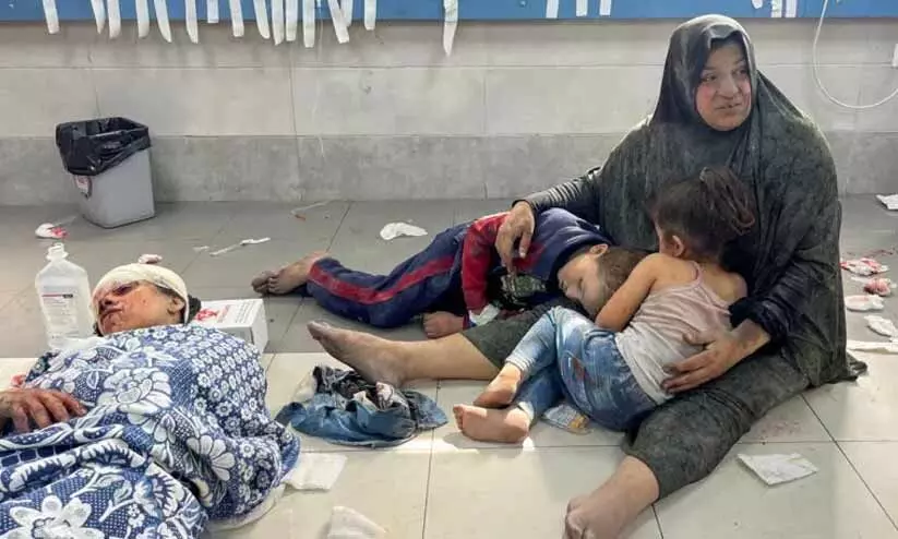A Palestinian woman holds her children at Al-Shifa Hospital in Gaza City on October 23, 2023, after an Israeli air strike wounded the family A Palestinian woman holds her children at Al-Shifa Hospital in Gaza City on October 23, 2023, after an Israeli air strike wounded the family