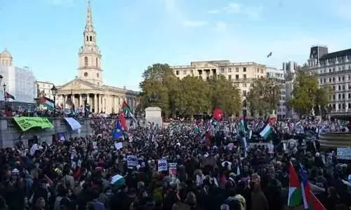 Protesters gather with placards and flags during the London Rally For Palestine in Trafalgar Square, central London