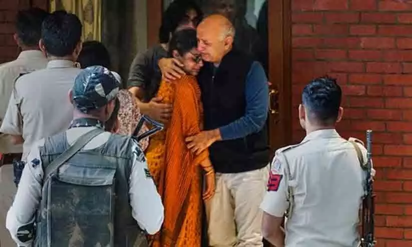 Kejriwal shares photo of Sisodia hugging wife before leaving Kejriwal shares photo of Sisodia hugging wife before leaving