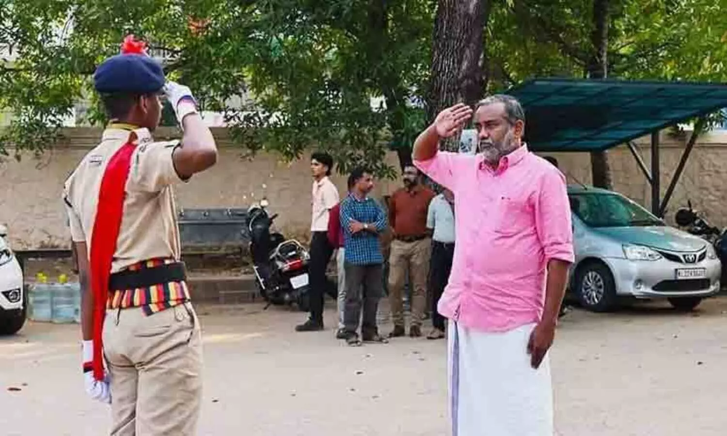 Minister P. Prasad was received with a salute by his son and student police cadet platoon commander Bhagat Prasad.