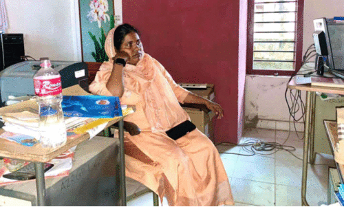 female panchayat member sat in office