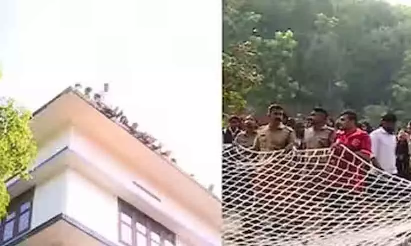 Law students threatened by climbing on top of the college building