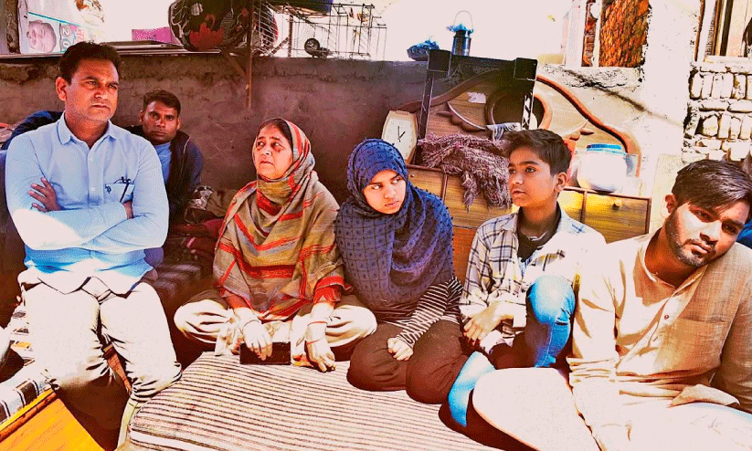 vakil hasan and family infront of destroyed home